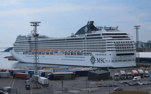 Cruise liner in the port of Helsinki. At the pier, a line of tru Stock Image