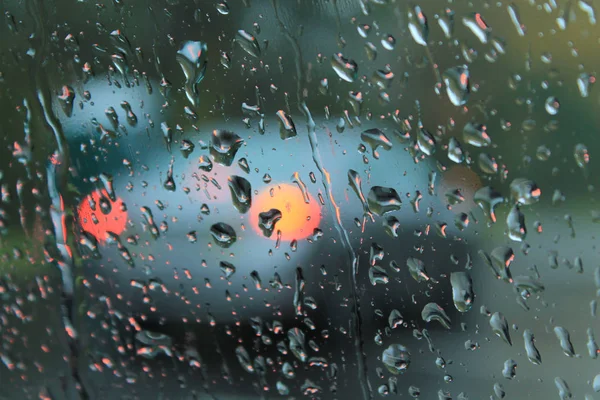 View of red car brake lights through a foggy window — Stock Photo, Image