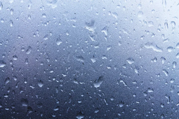 Large raindrops on a metallic silver surface — Stock Photo, Image