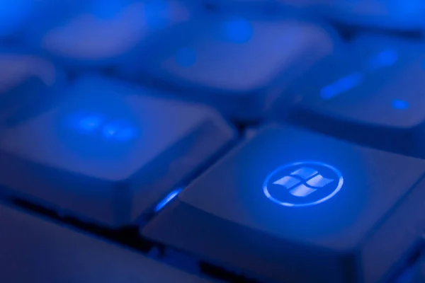 WINDOWS key illuminated by blue LED light. Close-up of keyboard.