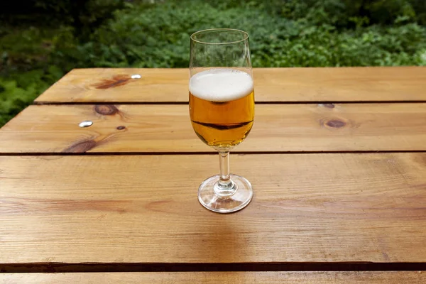 Glass of beer standing outside on a table