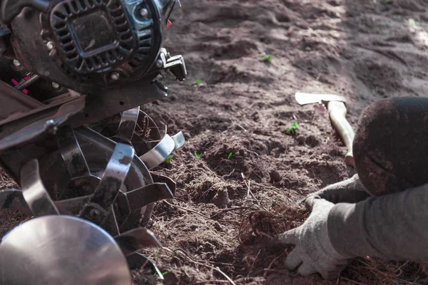 A person is working with gardening machinery