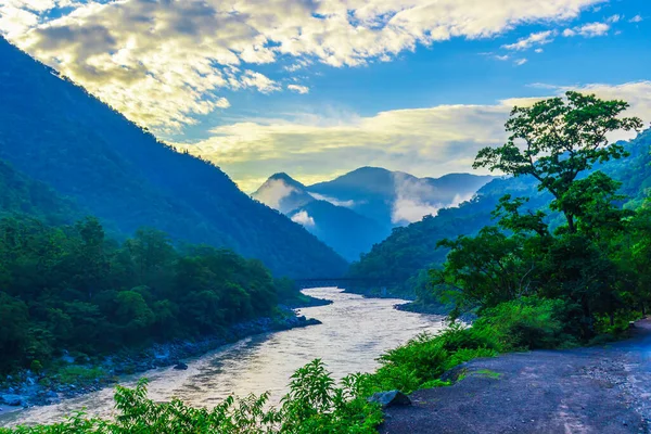 Gündoğumu Rishikesh 'te, Hindistan' ın kutsal kasabasında ve seyahat noktasında. Renkli gökyüzü ve bulutlar Ganj Nehri üzerinde yansıyor.