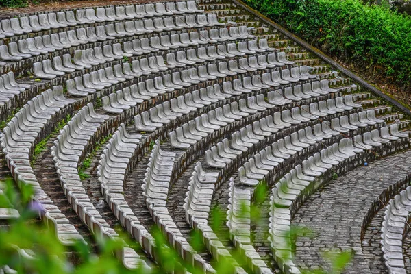 The grandstands of a modern outdoor amphitheater, a stage for small entertaining events, performances, concerts or presentations.