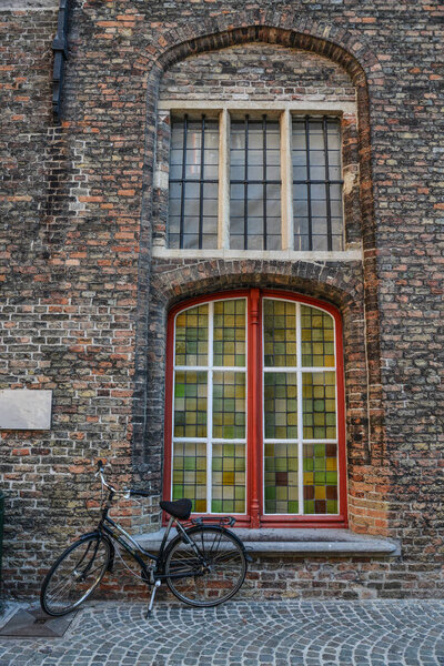 A bicycle on ancient street in Bruges, Belgium. Bruges (Brugge) is Belgium most perfectly preserved medieval town in Europe.