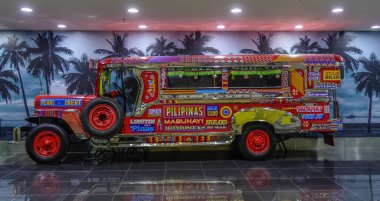 Manila, Philippines - Dec 4, 2018. A Jeepney for display in Manila Airport (NAIA). Jeepneys are buses and the most popular means of public transportation in Philippines. clipart