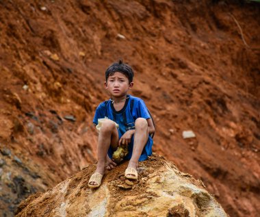 Sa Pa, Vietnam - 31 Mayıs 2016. Sa Pa, Vietnam kayaya oturan bir çocuk. Sa Pa Lao Cai, Kuzeybatı Vietnam bir dağ yeridir.