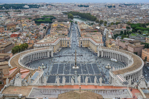 Looking down panorama view over Saint Peter Square (Piazza San Pietro) and Rome City, from St. Peter Basilica dome.
