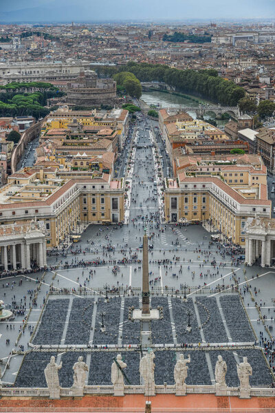 Looking down panorama view over Saint Peter Square (Piazza San Pietro) and Rome City, from St. Peter Basilica dome.