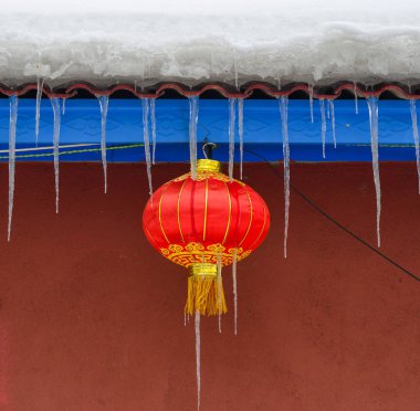 Hanging red lantern at brick house in Harbin, China. clipart