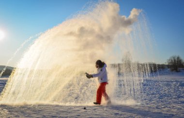 İnsanlar gün doğumunda kar atıyorlar. 