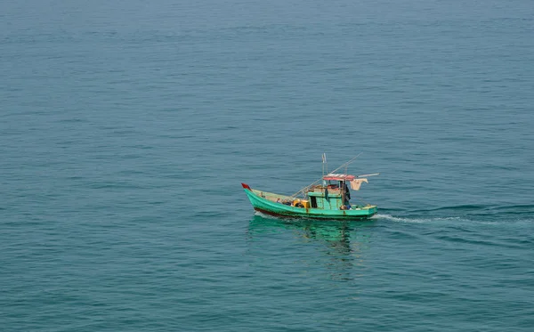 Wooden boat running on blue sea in Nam Du Island, Vietnam.