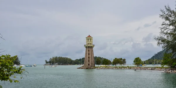 Stone lighthouse with the blue sea in Langkawi, Malaysia.