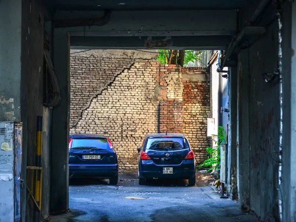 Cars parking at old brick house — Stock Photo, Image