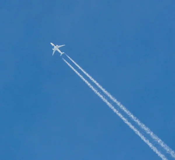 Plane at cruising altitude against blue sky