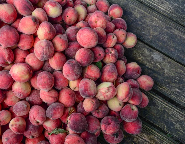 Rote Pfirsichfrüchte auf Holztisch — Stockfoto