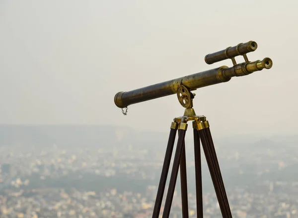 Vintage binocular telescope with cityscape