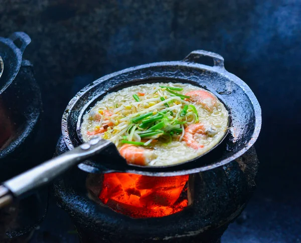 Cooking Vietnamese traditional seafood pancake