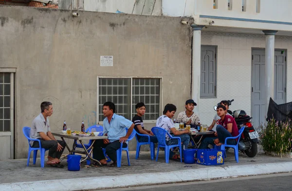 Местные мужчины пьют пиво на улице — стоковое фото