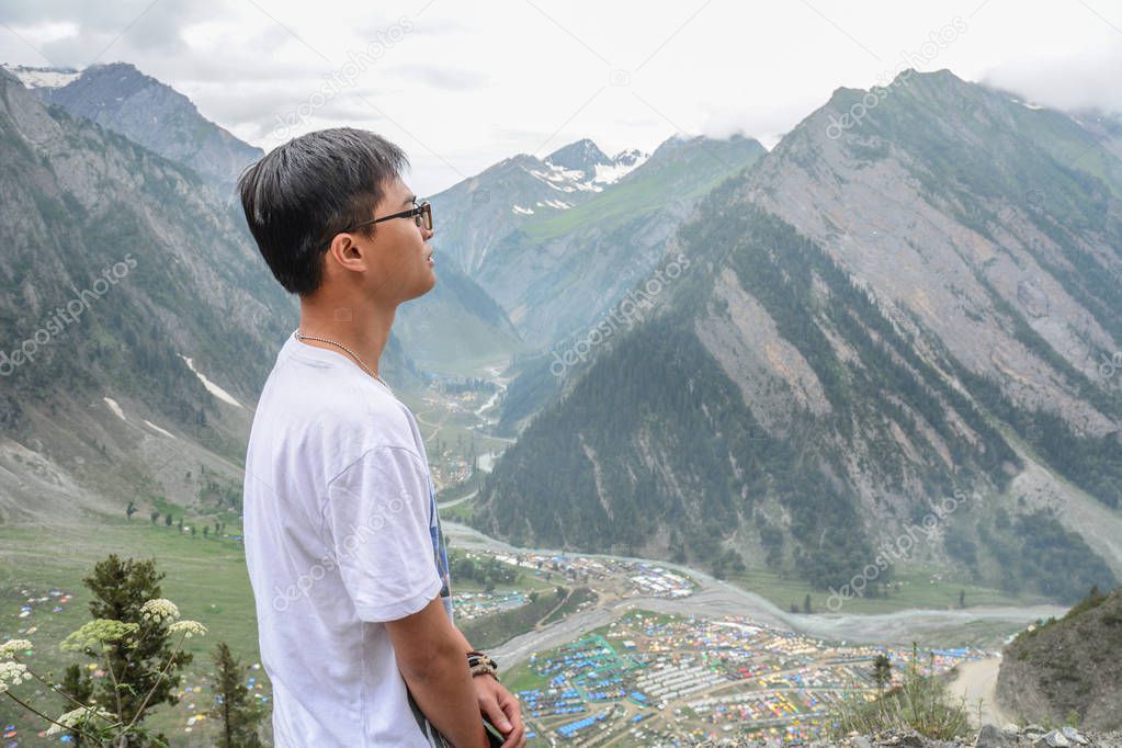 Young traveler standing on mountain 