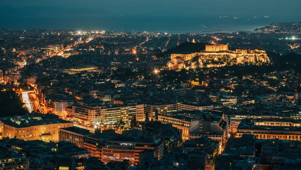 Night scene of Athens, Greece. Athens skyline at night viewed from Mount Lykavitos with Acropolis Hill.