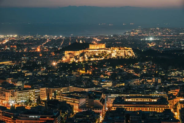 Night scene of Athens, Greece. Athens skyline at night viewed from Mount Lykavitos with Acropolis Hill.