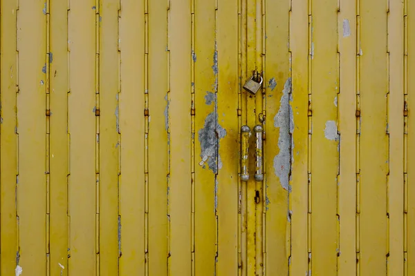 Yellow old steel door with lock — Stock Photo, Image