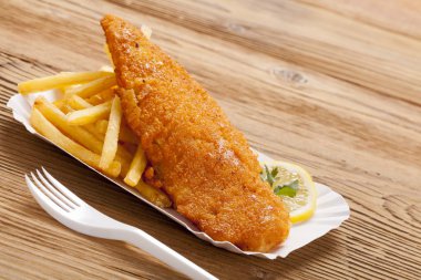 Kızarmış balık ve cips bir kağıt tepsisi üzerinde