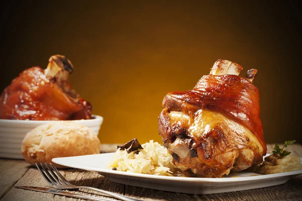 Geroosterd varkensvlees knokkel geserveerd met gekookte kool, brood, horseradis — Stockfoto