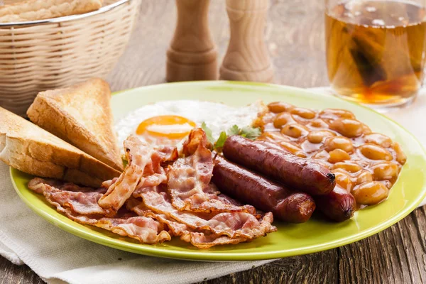 Compleet Engels ontbijt met spek, worst, gebakken ei, gebakken bea — Stockfoto