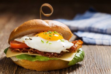 Kızarmış yumurta, pastırma, peynir ve sebzeli sandviç..