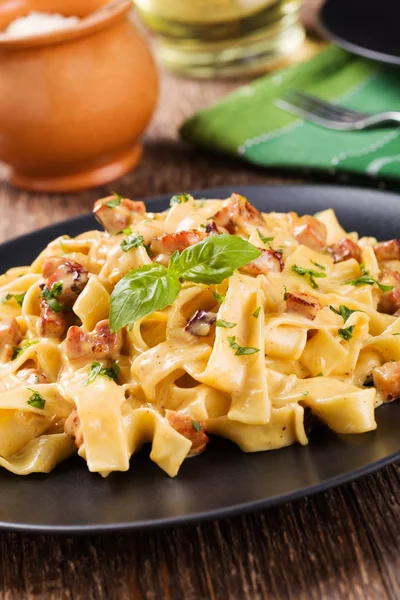 Pasta Carbonara with bacon, basil and cheese — Stock Photo, Image