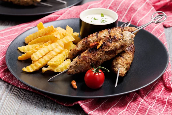 Barbecued kofta - kebeb with fries and vegetables on a plate. — Stock Photo, Image