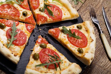 Pizza Vejetaryen taş siyah plaka üzerinde deneyin ile taze domates