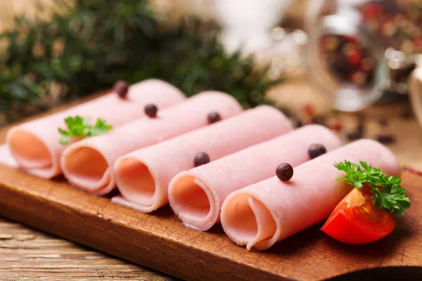 Delicious canned cooked ham on a wooden board with spices. — Stock Photo, Image