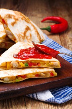 Tavuk ile Quesadilla, guacamole veya salsa sosuyla servis edilir..