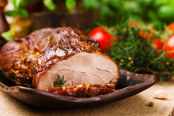 Roast pork with herbs and vegetables.