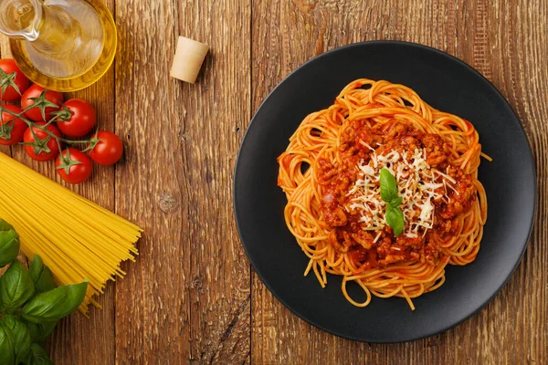 Läcker spaghetti serveras på en svart tallrik — Stockfoto