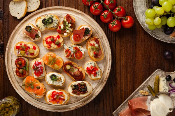 Crostini Different Toppings Wooden Background Delicious Appetizers Top View — Stock Photo, Image