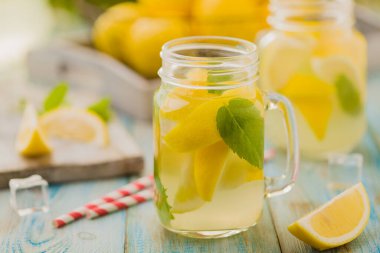 Nane şekerli limonata ve bir kavanozda servis edilmiş tahta bir masada pipetle..