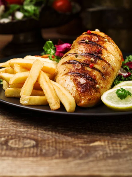 Grilled Chicken Breast Green Salad French Fries Black Plate — Stock Photo, Image