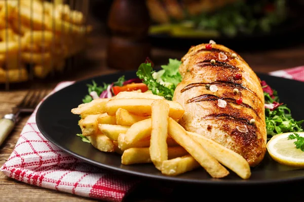 Grilled Chicken Breast Green Salad French Fries Black Plate — Stock Photo, Image