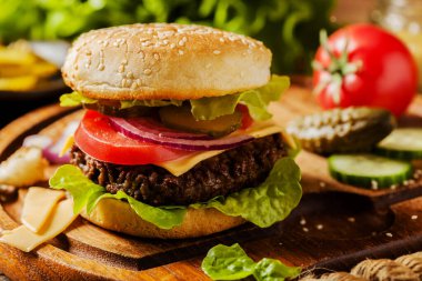 Ev yapımı, peynirli ve sebzeli sığır burger. Üst görünüm.