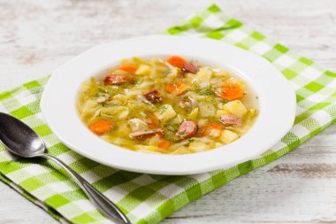 Ev yapımı lahana çorbası, füme pirzola ile pişirilmiş. Ön görünüm.