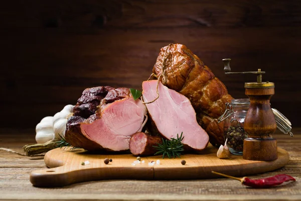 Smoked pork on wooden board. Different types of meat.