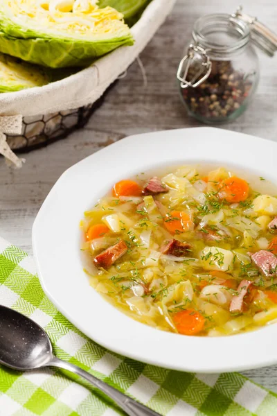 Homemade cabbage soup, cooked on smoked ribs. Front view.