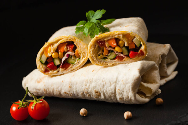 Tortilla with vegetables and hummus with chickpeas. Front view. 