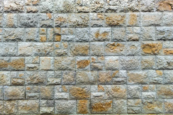 wall of square stones in light tones