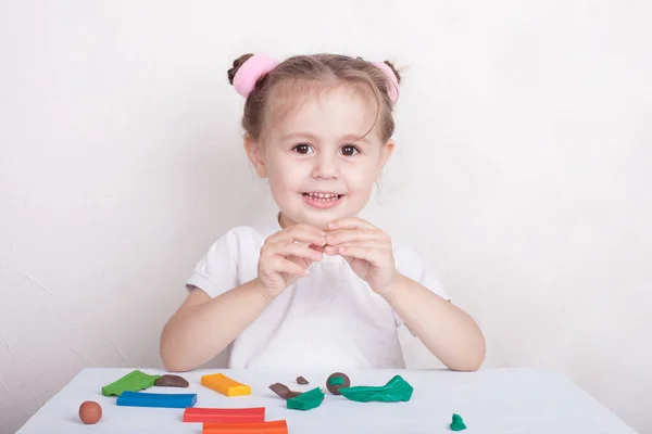 Development of small motor skills of children. The girl molds from plasticine