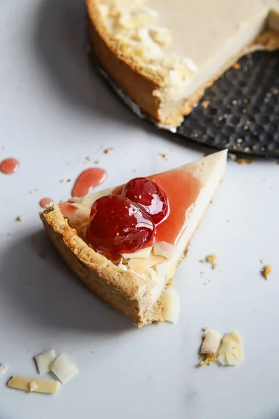 Coconut custard pie with strawberry jam on marble background